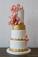 White tiers with vintage gold accent and pink sugar flowers