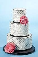Three tier black and white polka dot cake with pink gumpaste peonies