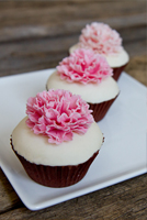 Carnation topped fondant cupcakes.