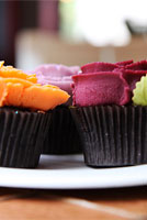 Orange and purple buttercream rose cupcakes.